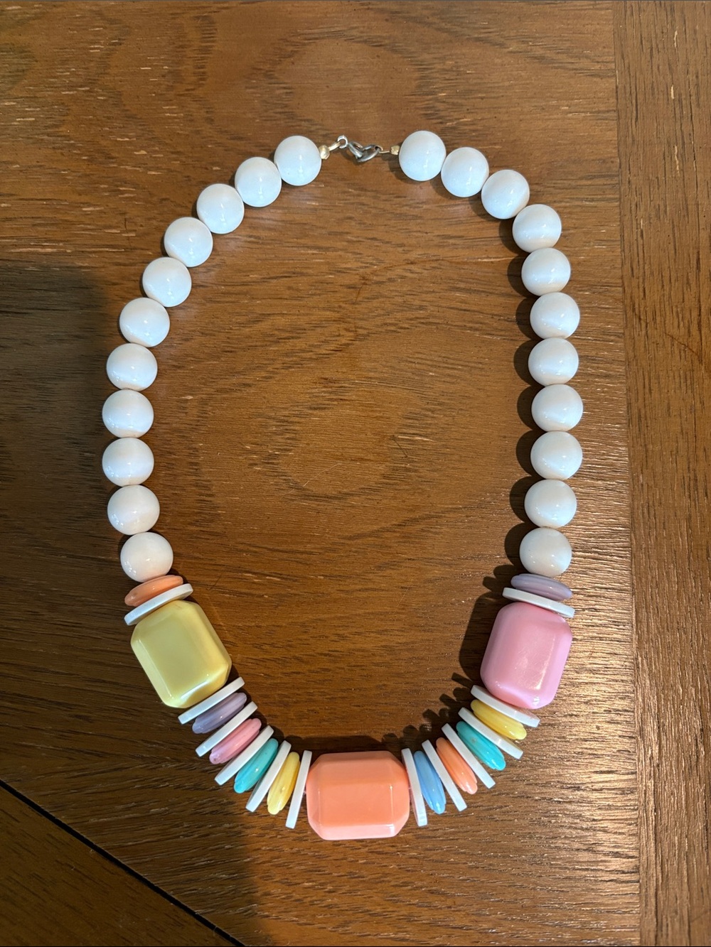 Chunky statement necklace with white round beads and pastel-colored accent beads